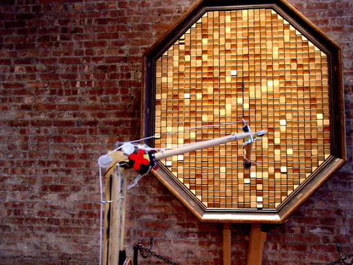 The arm transforms Danny Rozin's WOODEN MIRROR into a self-animating piece. The arm transforms Danny Rozin's WOODEN MIRROR into a self-animating piece.